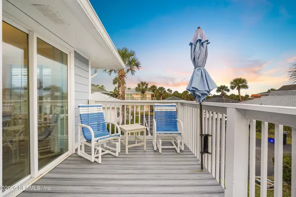 a view of a chairs and table on the deck