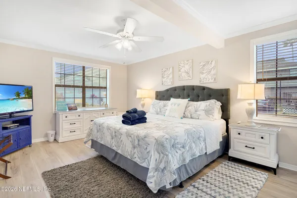 a bedroom with a bed and a large window