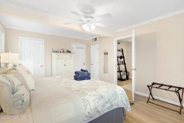 a bedroom with a bed and a ceiling fan