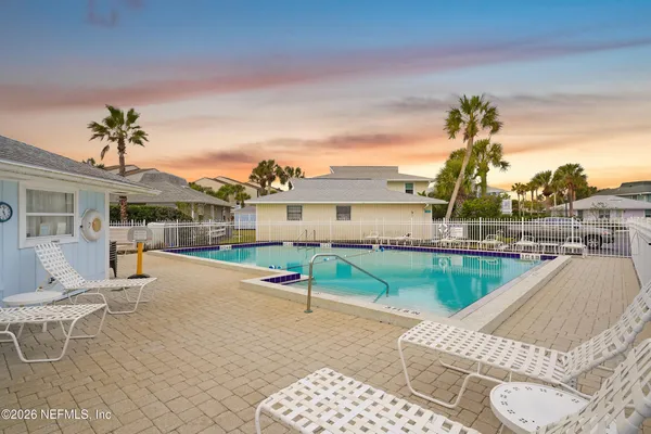 a view of a patio with table and chairs potted plants with wooden fence