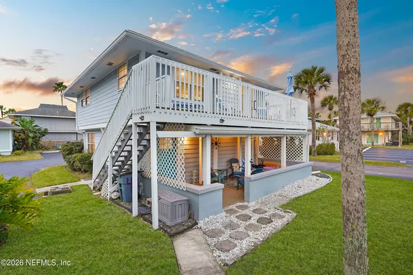 a front view of a house with a yard table and chairs