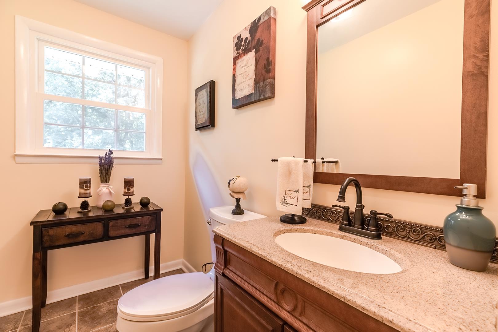 7574 King Road Fairview, TN 37062 - Photo 12 of 30 a bathroom with a granite countertop sink toilet and mirror