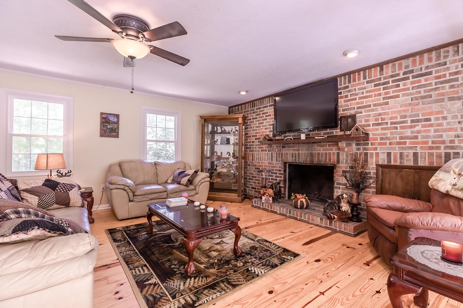 7574 King Road Fairview, TN 37062 - Photo 17 of 30 a living room with furniture a flat screen tv and a fireplace