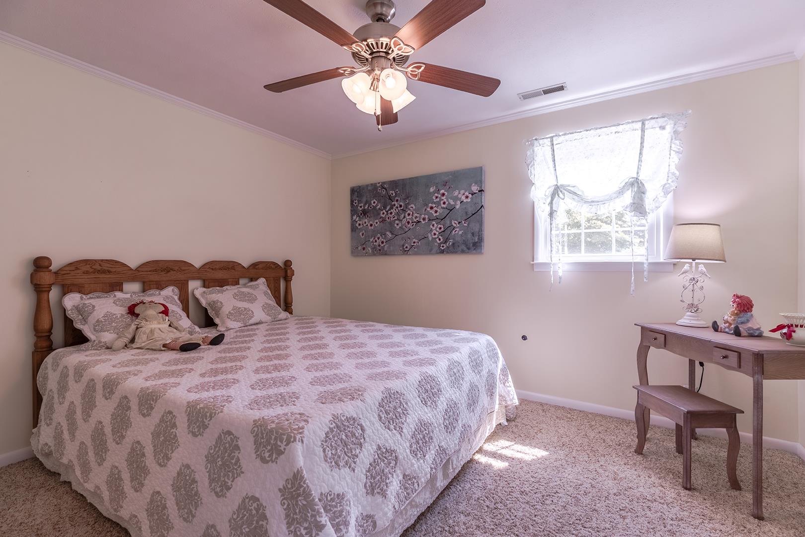 7574 King Road Fairview, TN 37062 - Photo 23 of 30 a bedroom with a bed and a chandelier