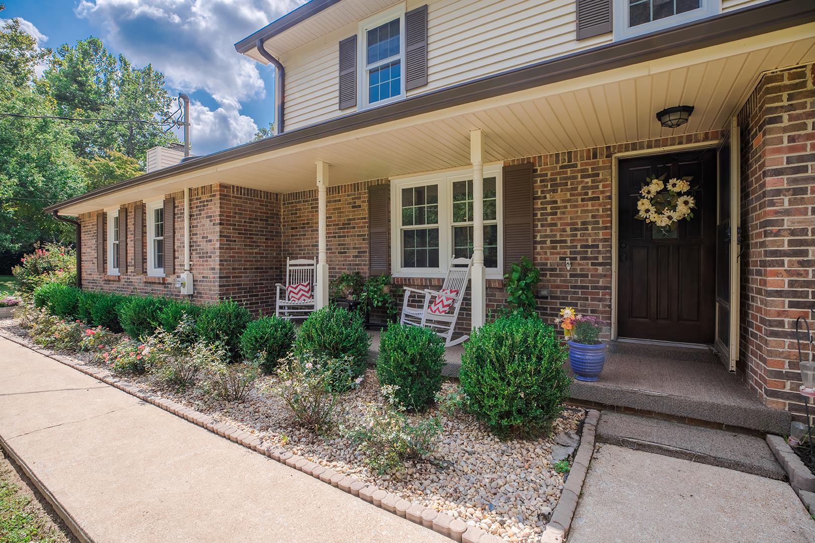 7574 King Road Fairview, TN 37062 - Photo 25 of 30 a view of a brick house with plants and large windows