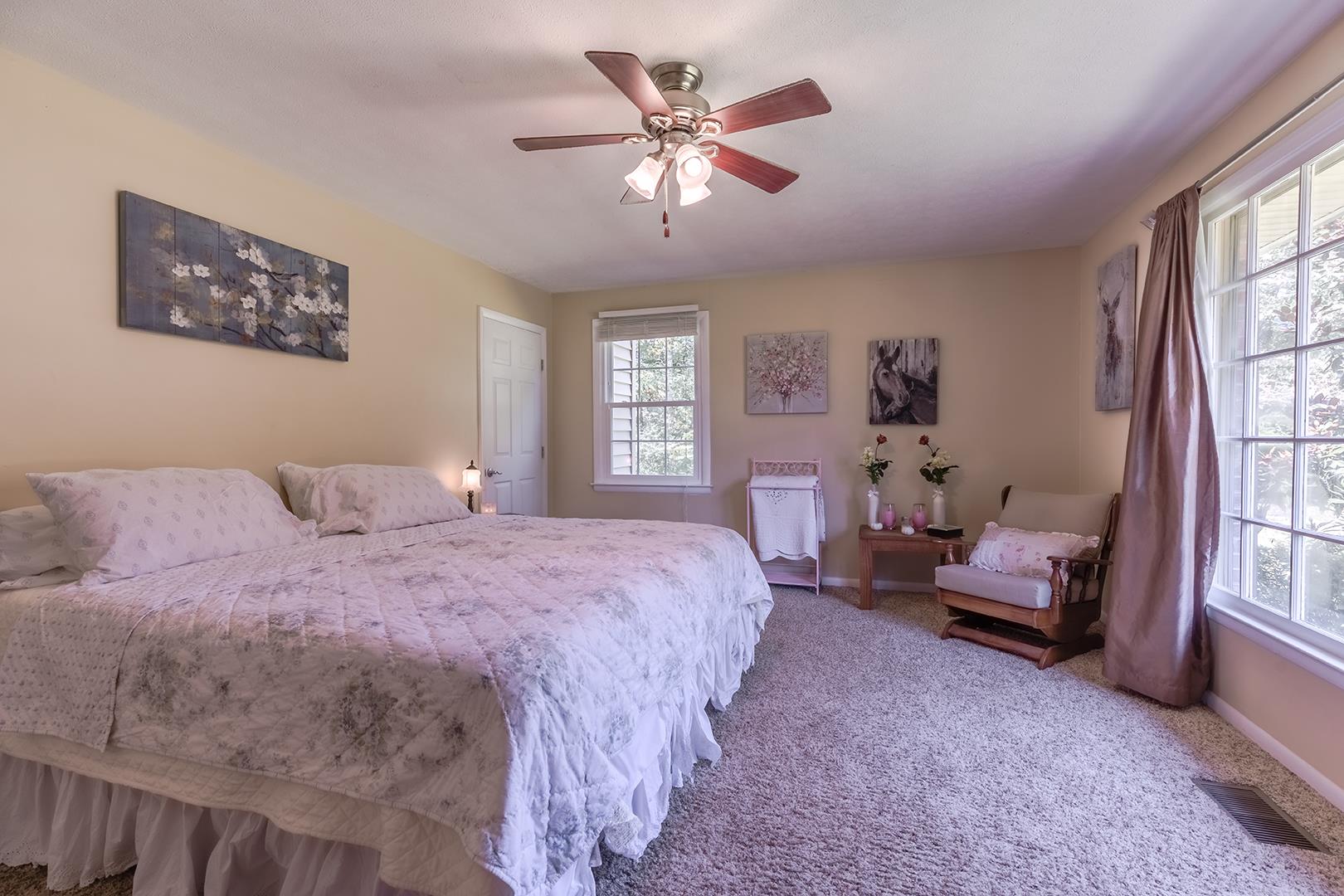 7574 King Road Fairview, TN 37062 - Photo 9 of 30 a spacious bedroom with a bed and a chandelier