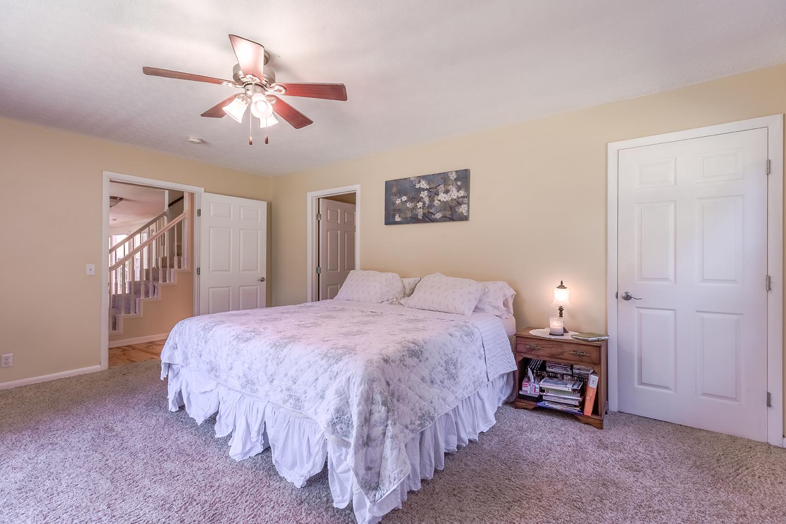 7574 King Road Fairview, TN 37062 - Photo 10 of 30 a bedroom with a bed and a chandelier