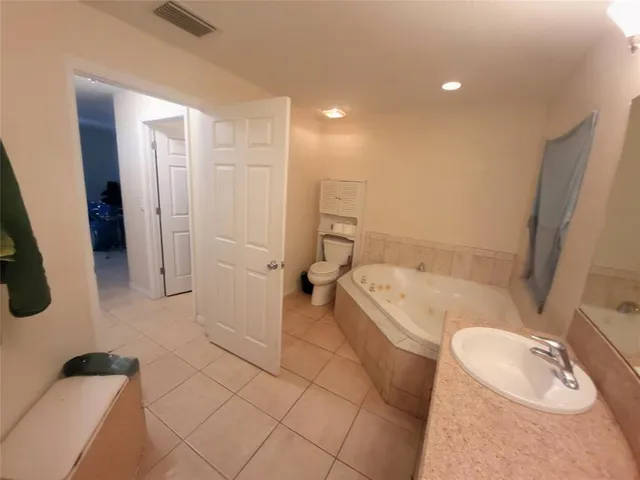 a bathroom with a tub a toilet and a shower