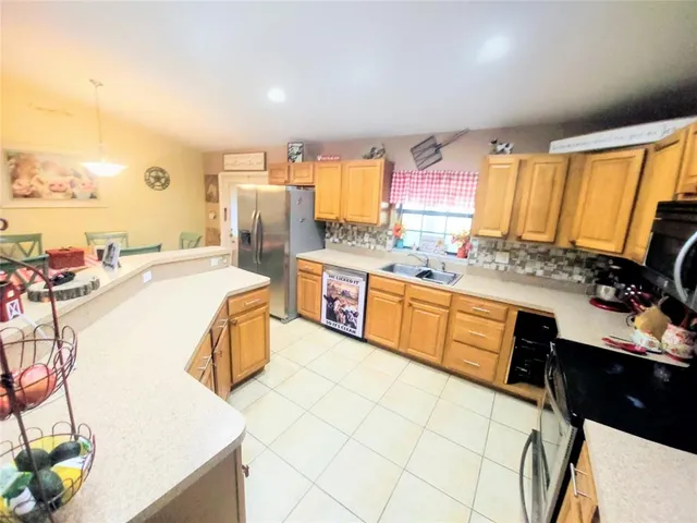 a kitchen with a sink appliances and cabinets