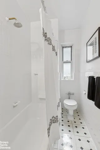 a bathroom with a toilet sink and shower