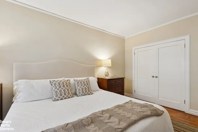 a bedroom with a bed and a night stand