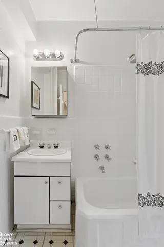 a bathroom with a bathtub a sink and mirror
