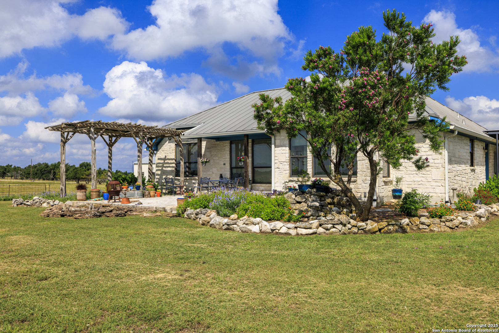 564 Gypsum Mine Road Fredericksburg, TX 78624 - Photo 13 of 20 a view of a house with backyard porch and sitting area