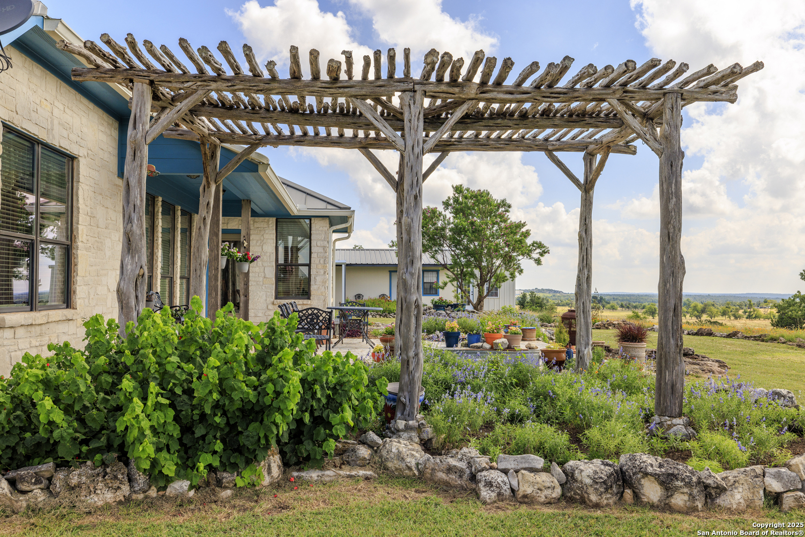564 Gypsum Mine Road Fredericksburg, TX 78624 - Photo 19 of 20 a view of a house with a flower garden