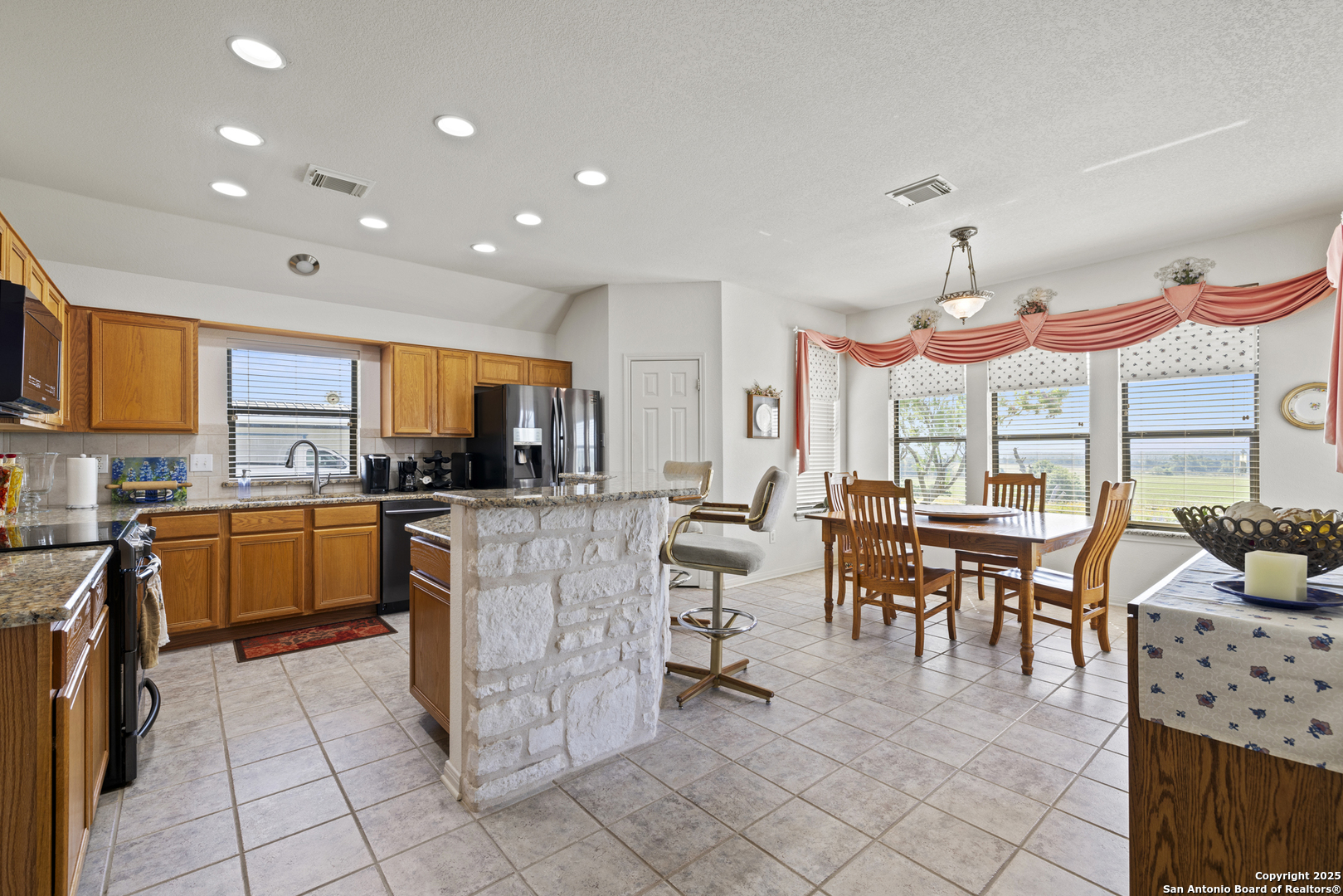 564 Gypsum Mine Road Fredericksburg, TX 78624 - Photo 3 of 20 a large kitchen with lots of counter and chairs
