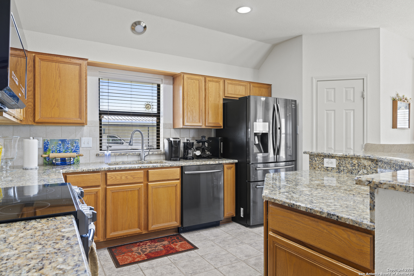 564 Gypsum Mine Road Fredericksburg, TX 78624 - Photo 4 of 20 a kitchen with stainless steel appliances granite countertop a stove a sink dishwasher a refrigerator and cabinets with wooden floor