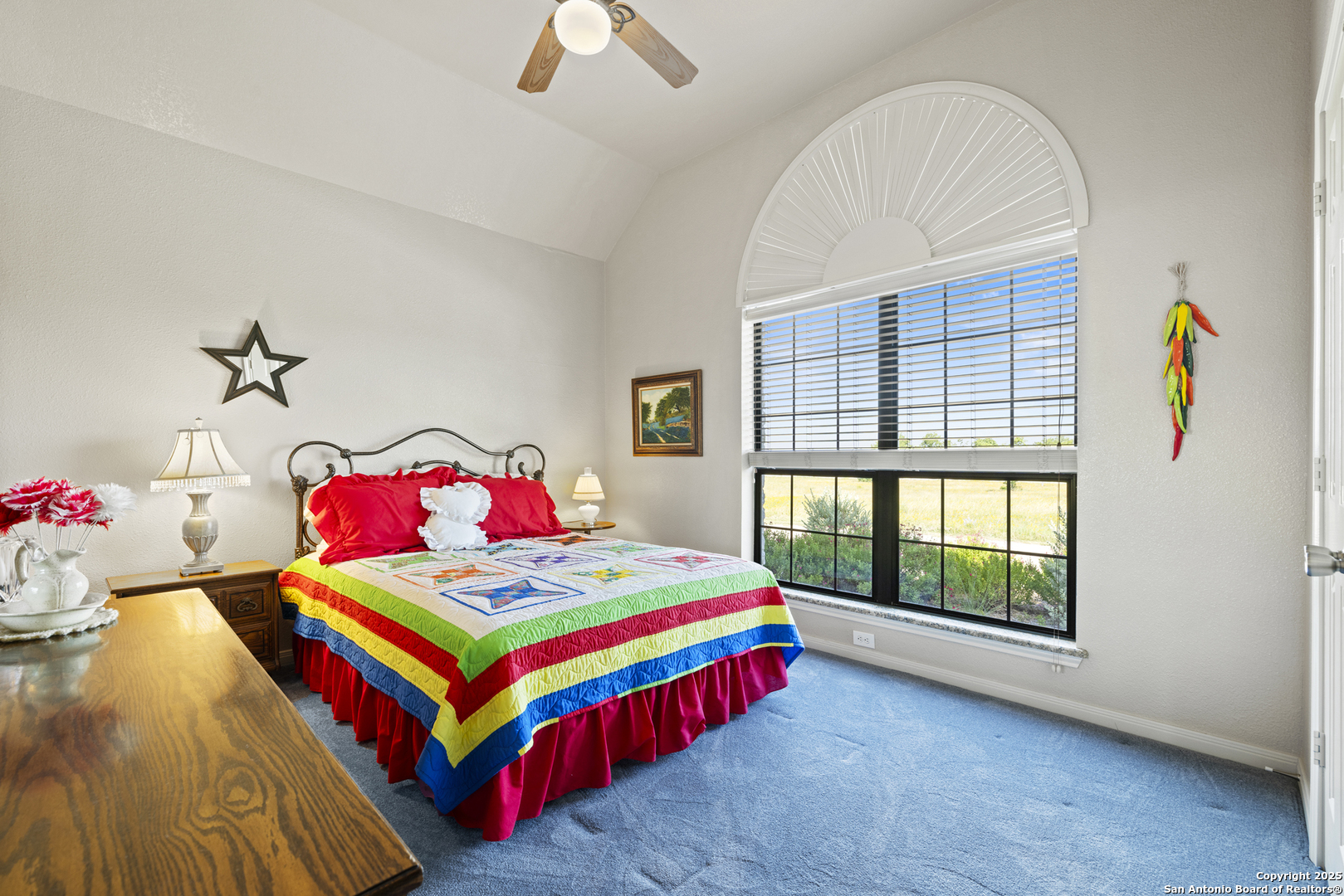 564 Gypsum Mine Road Fredericksburg, TX 78624 - Photo 8 of 20 a bedroom with a bed and a chandelier