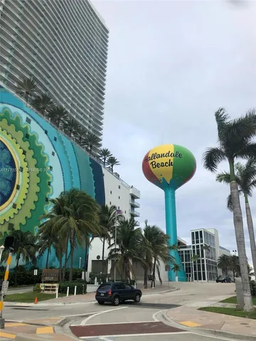 a view of a water fountain with potted plants