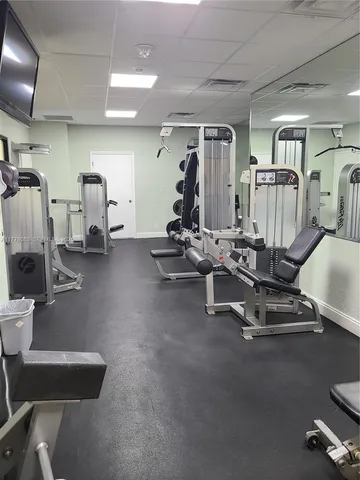 a room with gym equipment and mirrors