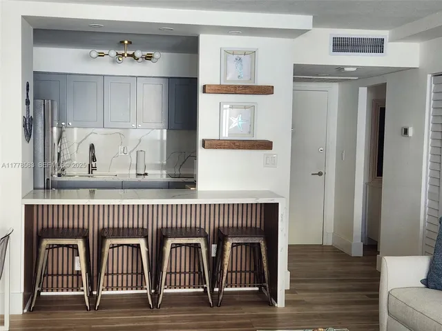a view of a hallway with entryway wooden floor and front door