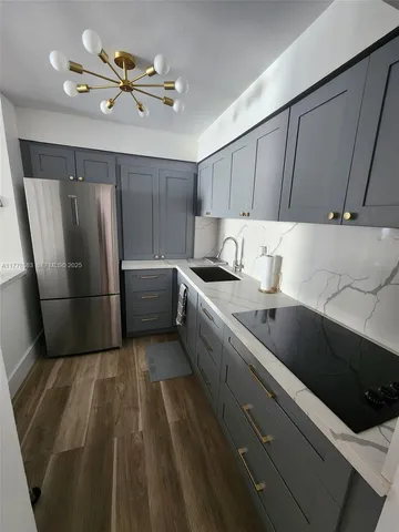 a kitchen with a refrigerator and a sink