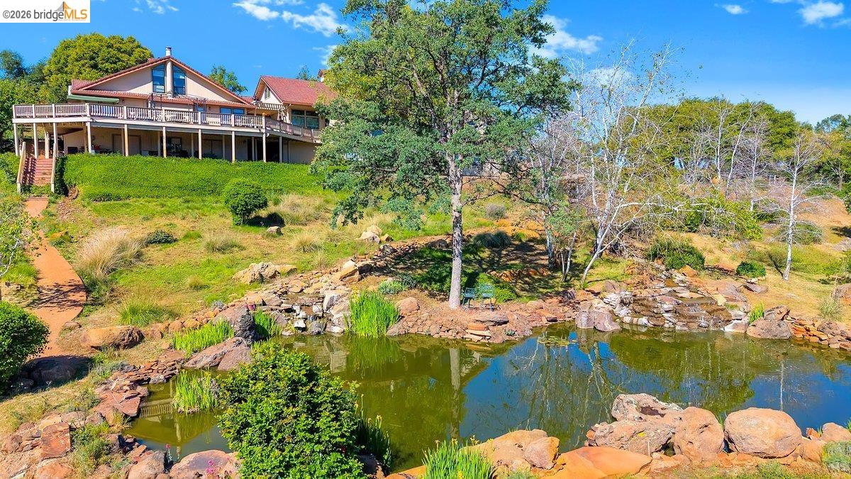 13700 Clements Road Groveland, CA 95321 - Photo 2 of 93 Terraced hillside property featuring a multi-level deck and a private pond with a rock waterfall feature