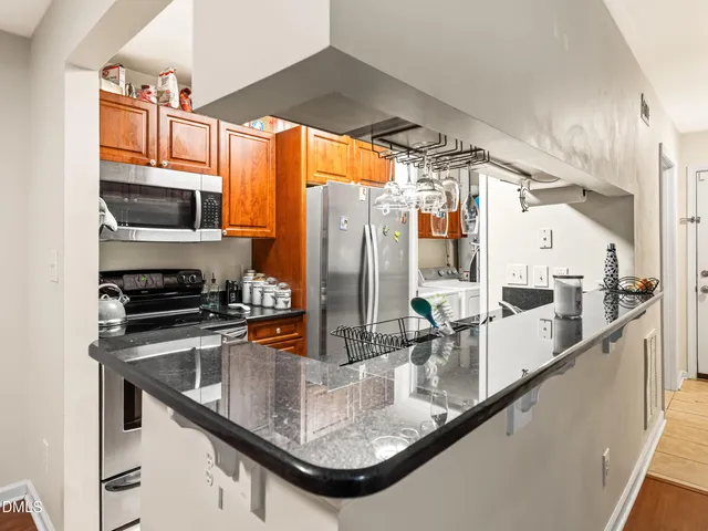 a kitchen with a sink appliances and cabinets