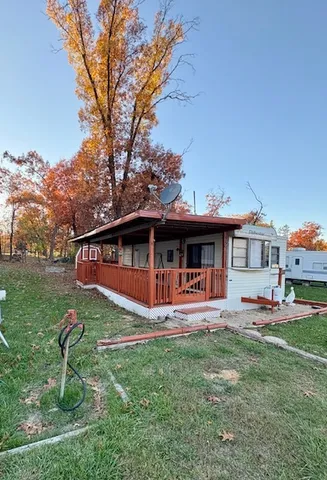 a front view of a house with a yard table and chairs