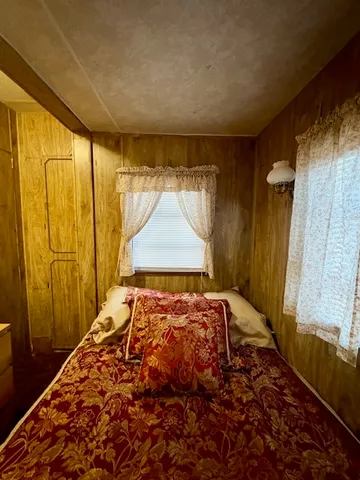 a bedroom with a bed and a table