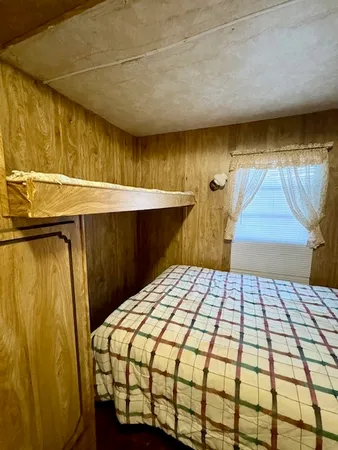 a bed sitting in a bedroom next to a window