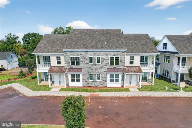a front view of residential houses with yard and swimming pool