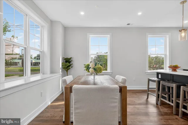 a dining room with furniture and wooden floor