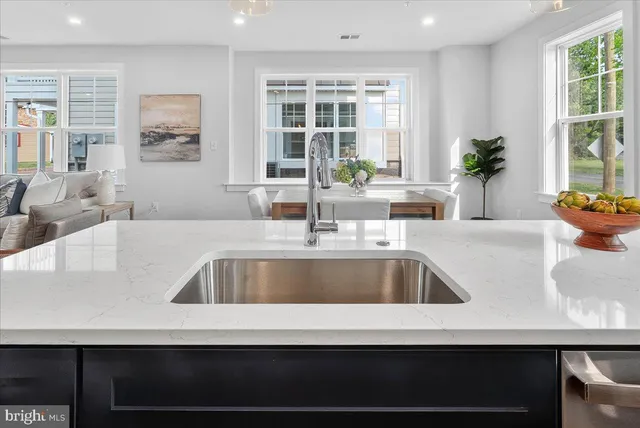a bathroom with a granite countertop shower a toilet and a sink