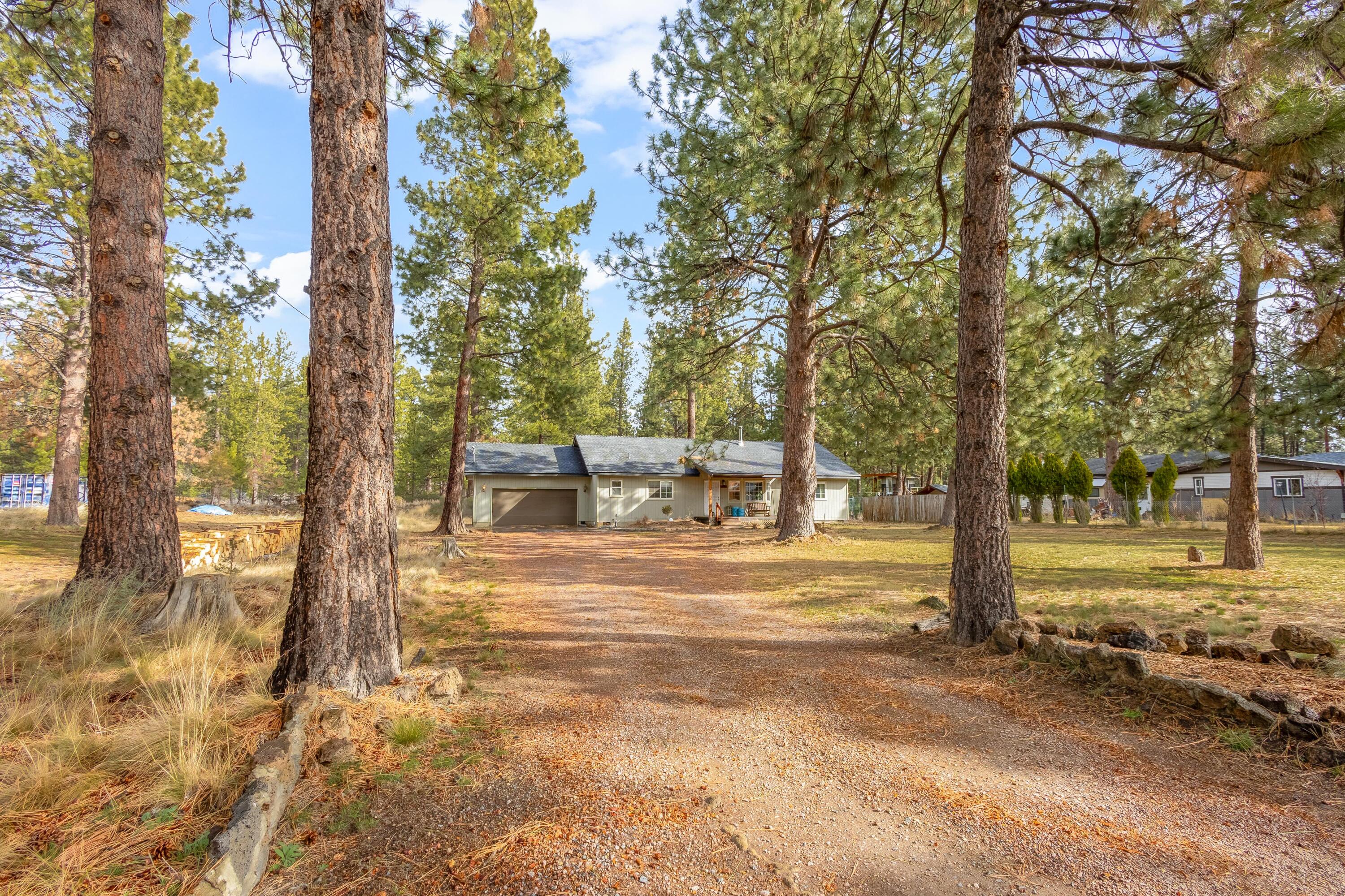 18900 Tuscarora Lane Bend, OR 97702 - Photo 1 of 20 a view of a house with a yard and tree s