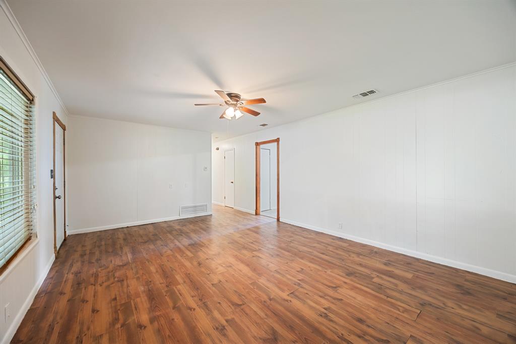 571 South 1st Street Point, TX 75472 - Photo 7 of 27 a view of an empty room with wooden floor and a window