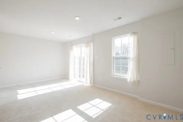 a view of an empty room with a kitchen