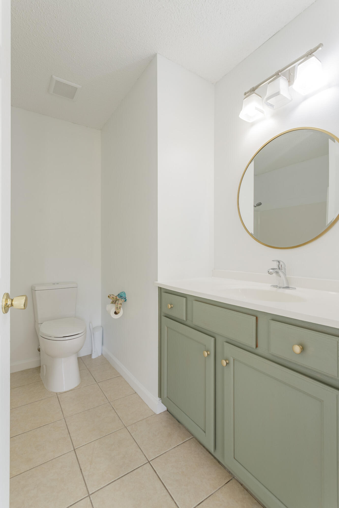 2233 Lewis Street Crestview, FL 32536 - Photo 13 of 24 a bathroom with a toilet sink and mirror