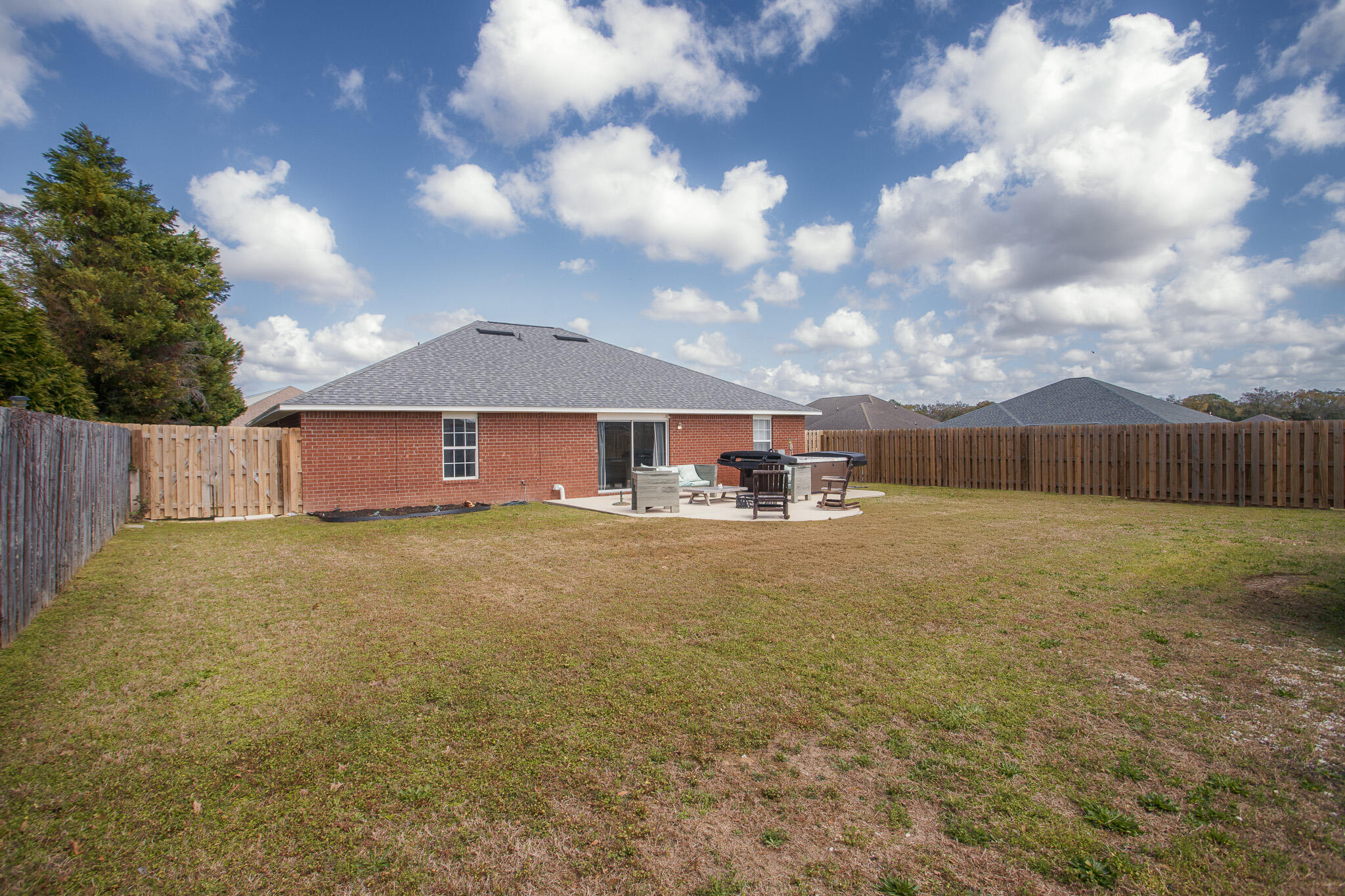 2233 Lewis Street Crestview, FL 32536 - Photo 23 of 24 a view of a yard with wooden fence