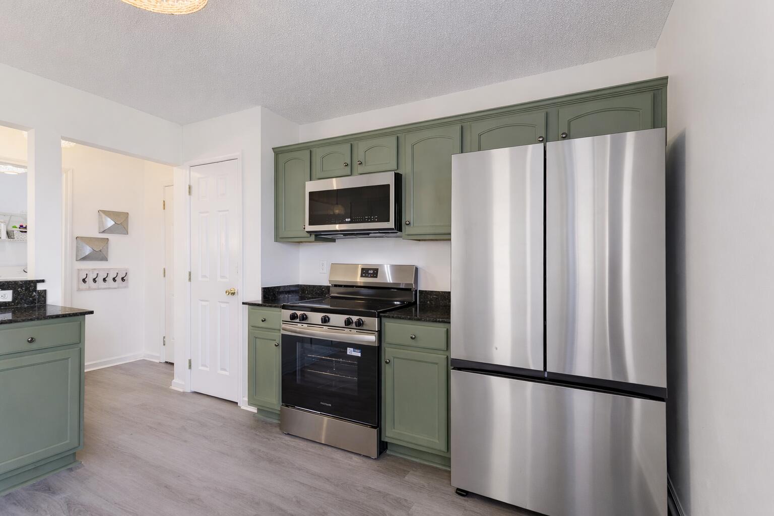 2233 Lewis Street Crestview, FL 32536 - Photo 6 of 24 a kitchen with stainless steel appliances a refrigerator stove and microwave
