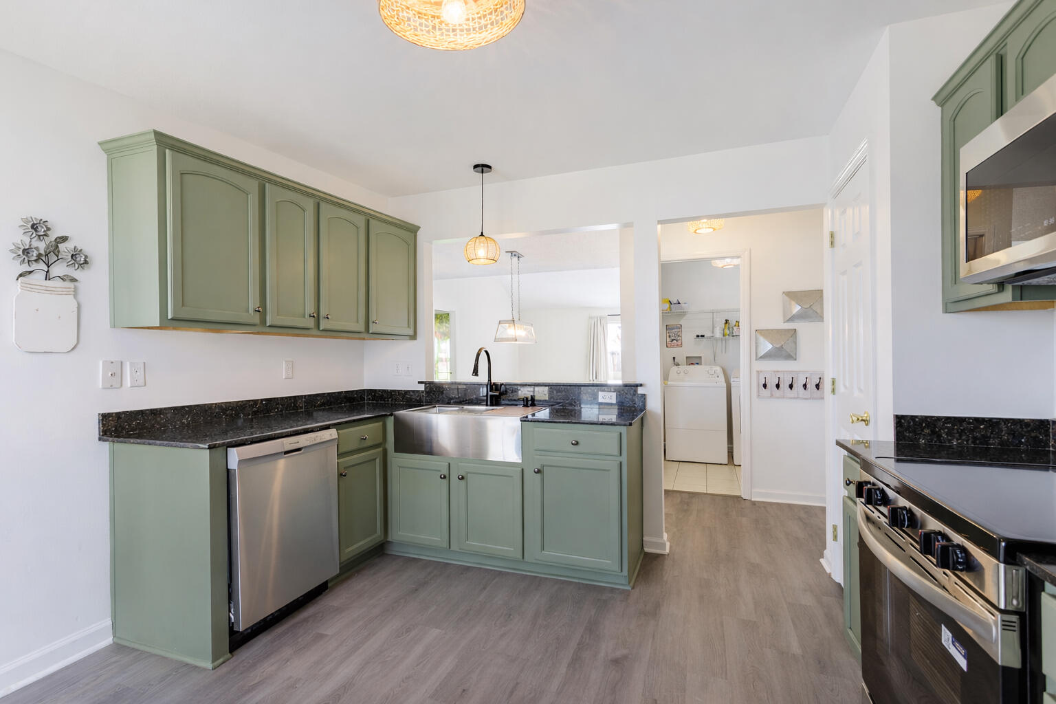 2233 Lewis Street Crestview, FL 32536 - Photo 7 of 24 a kitchen with a sink cabinets and wooden floor