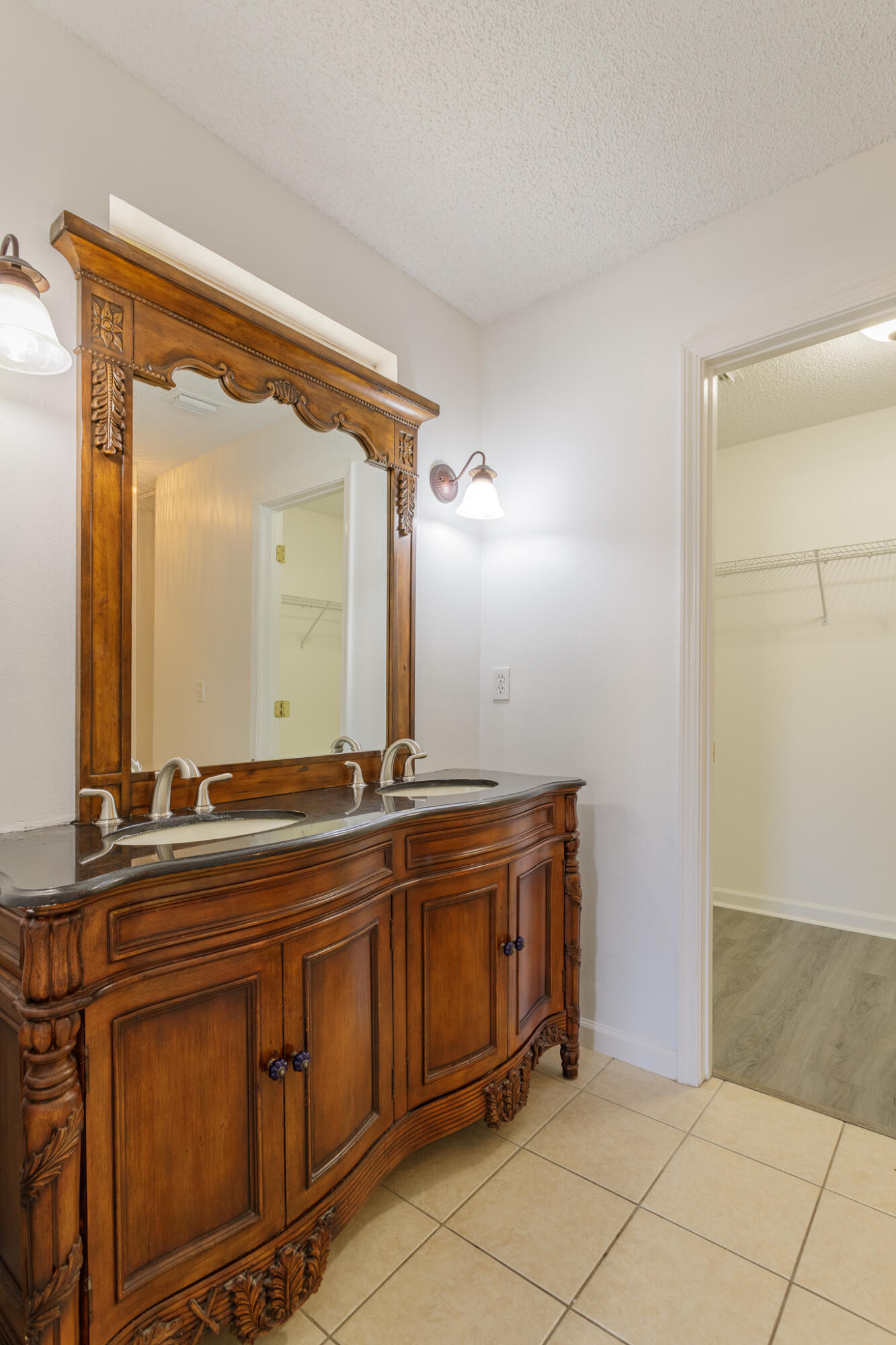 2233 Lewis Street Crestview, FL 32536 - Photo 9 of 24 a bathroom with a granite countertop sink and a mirror