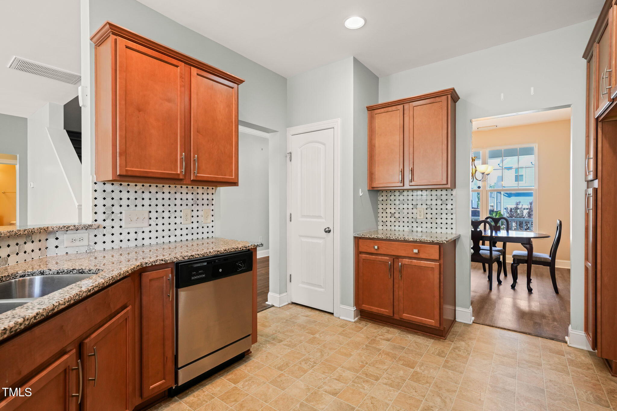 4508 Brintons Cottage Street Raleigh, NC 27616 - Photo 11 of 46 a kitchen with granite countertop a sink stove and cabinets