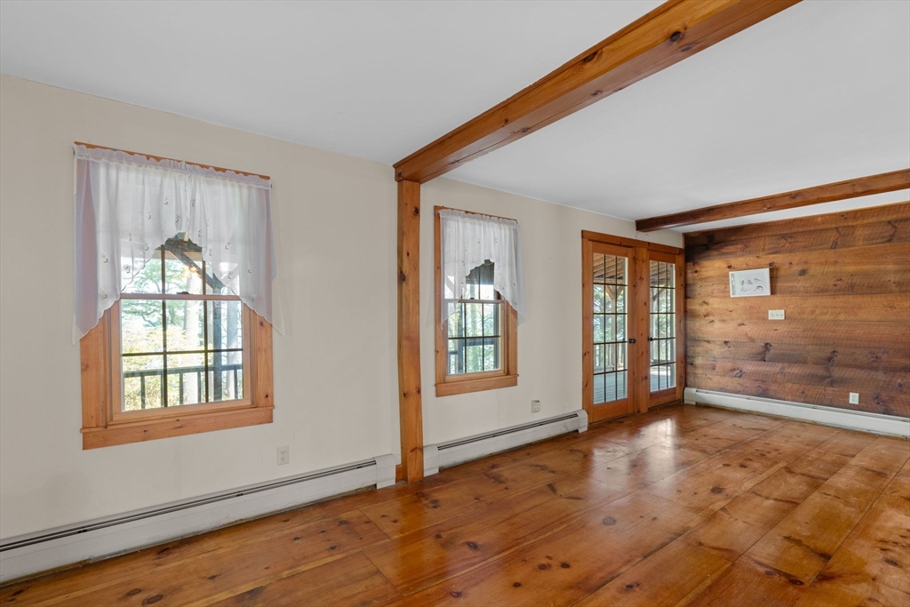 362 Snows Pond Road Rochester, MA 02770 - Photo 6 of 41 a view of an empty room with glass door and wooden floor