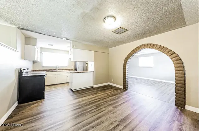 a view of a kitchen with wooden floor and a kitchen