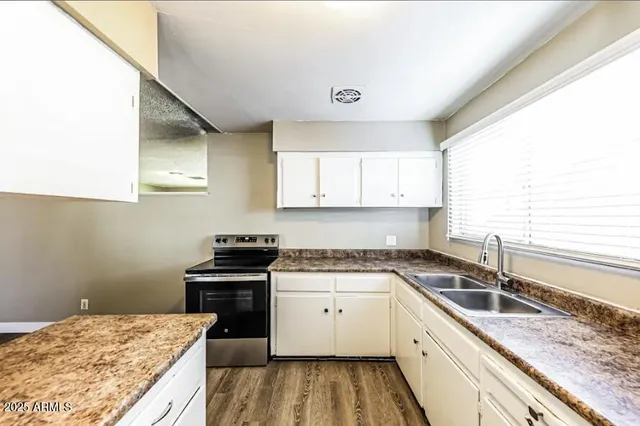 a kitchen with a sink stove and cabinets
