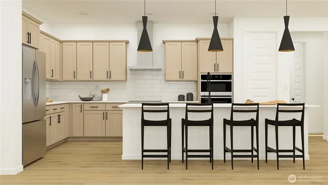 a kitchen with appliances cabinets and chair