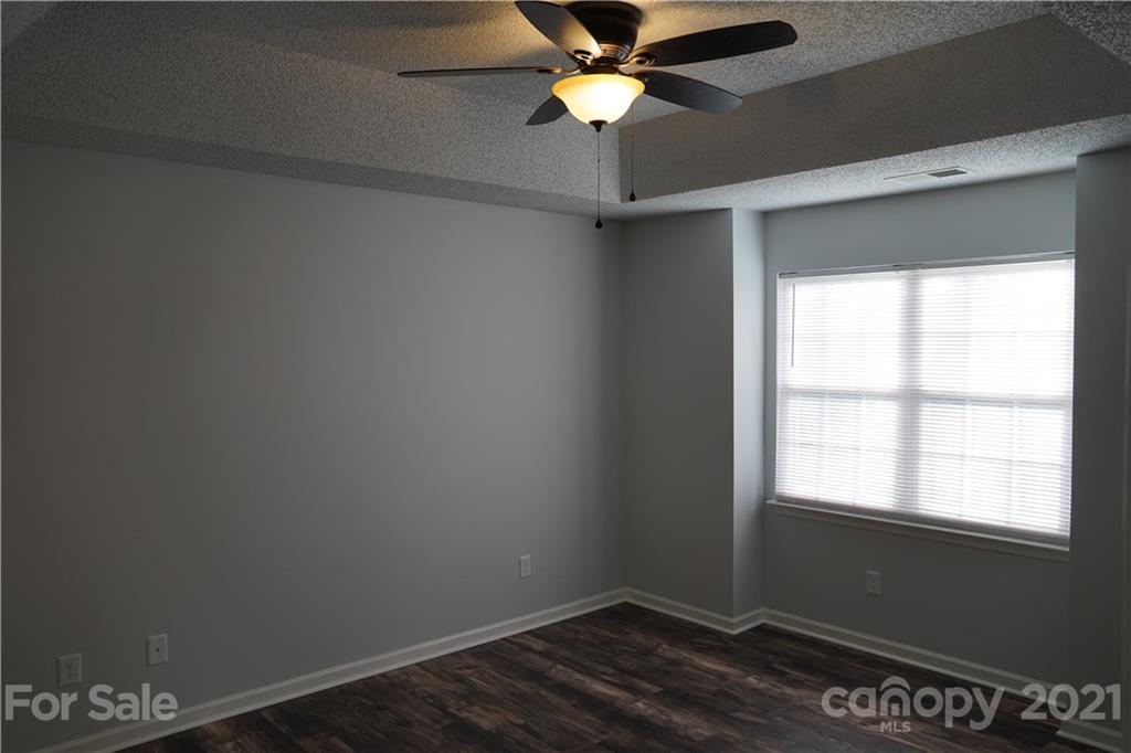 15220 Leslie Brooke Road Huntersville, NC 28078 - Photo 13 of 20 an empty room with a window and a fan