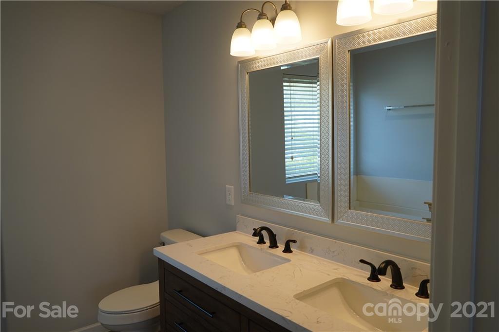 15220 Leslie Brooke Road Huntersville, NC 28078 - Photo 15 of 20 a bathroom with a granite countertop sink toilet and mirror