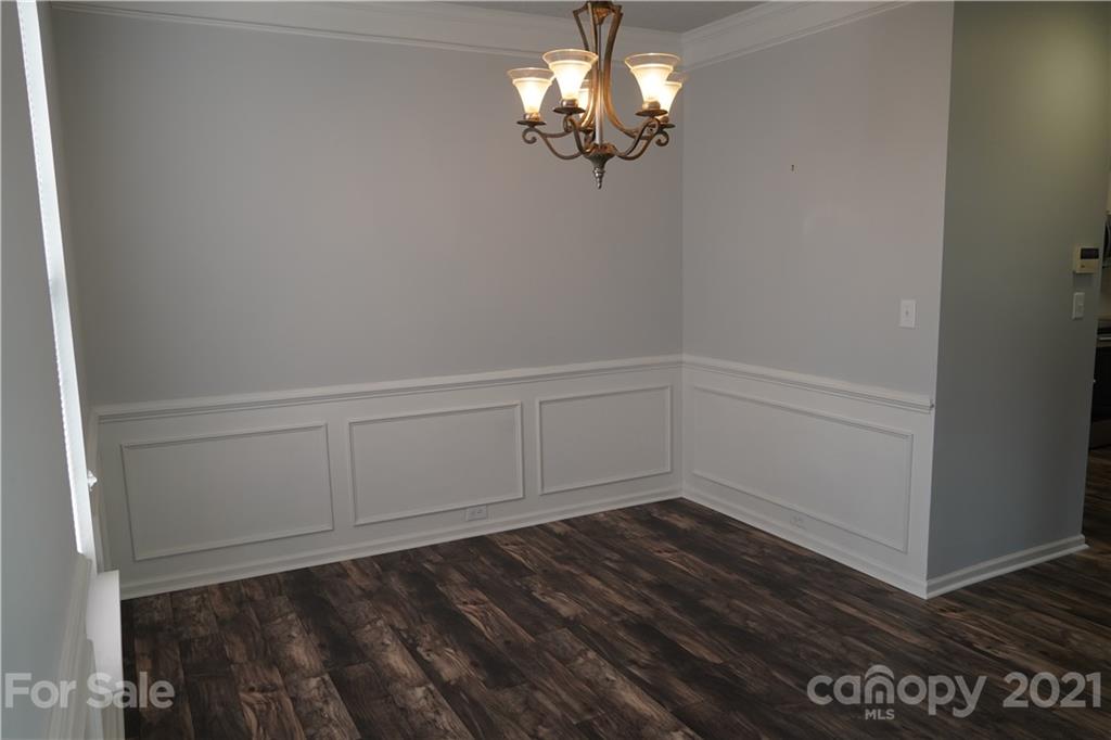 15220 Leslie Brooke Road Huntersville, NC 28078 - Photo 5 of 20 a view of a room with wooden floor and ceiling fan