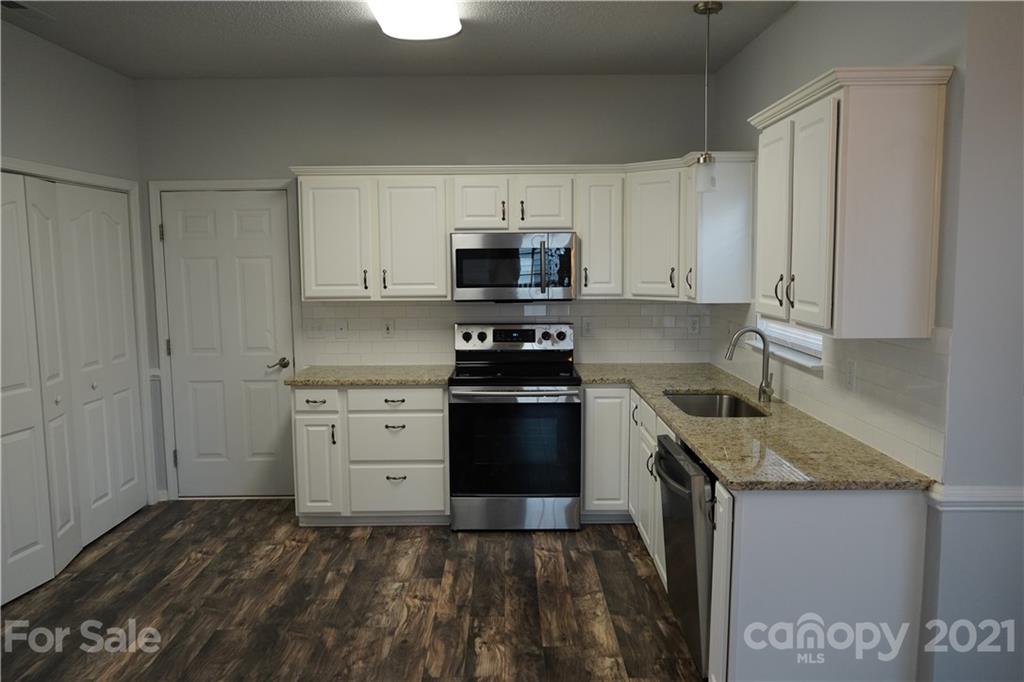 15220 Leslie Brooke Road Huntersville, NC 28078 - Photo 9 of 20 a kitchen with a stove and a sink